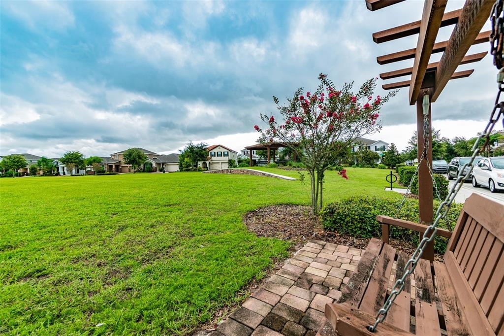 10624 Reams Road Windermere, FL 34786 - Photo 44 of 61 a view of a garden with a bench in the garden
