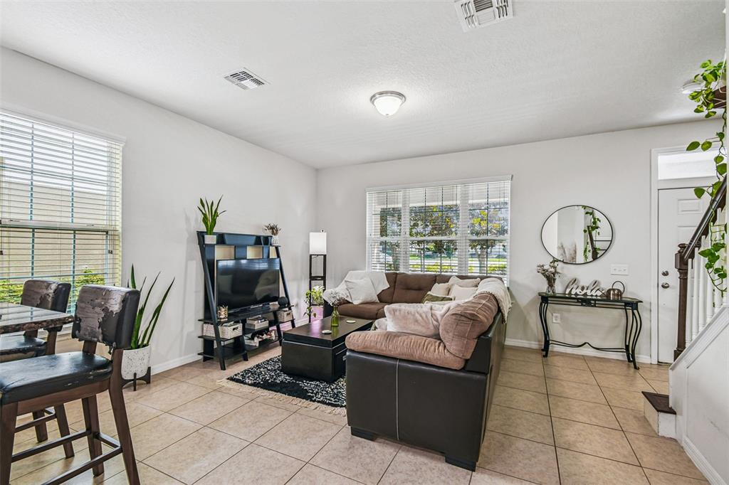 10624 Reams Road Windermere, FL 34786 - Photo 8 of 61 a living room with furniture a window and a flat screen tv