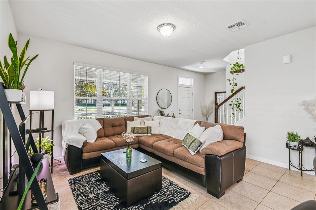 10624 Reams Road Windermere, FL 34786 - Photo 9 of 61 a living room with furniture a lamp and a potted plant