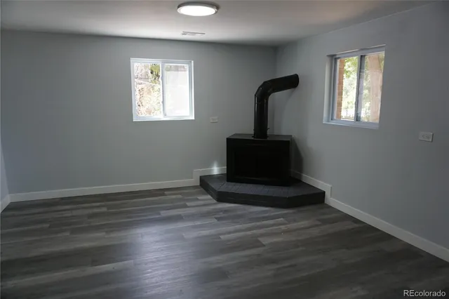 a room with a wooden floor washer and dryer