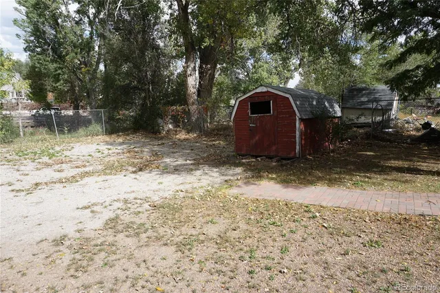 a view of a balcony with wooden floor and fence