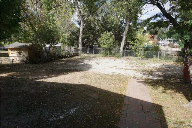 a view of a yard with large trees