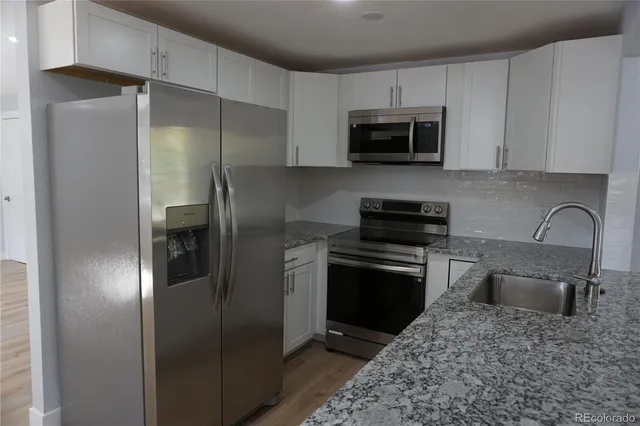 a kitchen with a refrigerator stove and microwave