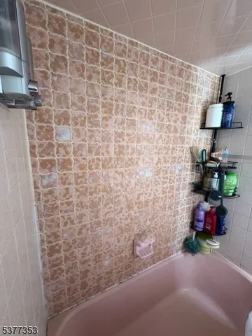 a spacious bedroom with a bed and a chandelier