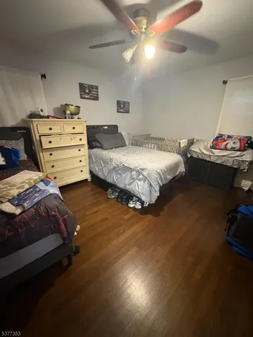 a bedroom with a large bed and a large mirror