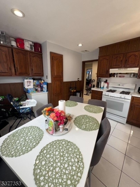 128 Grove Street, Unit 2 Bloomfield, NJ 07003 - Photo 21 of 33 a kitchen with stainless steel appliances granite countertop a sink dishwasher and a stove with wooden cabinets