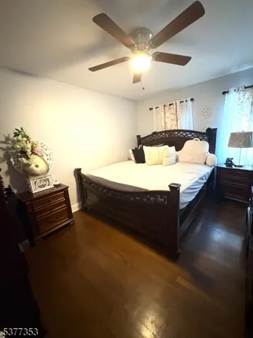 a living room with furniture a flat screen tv and a large window