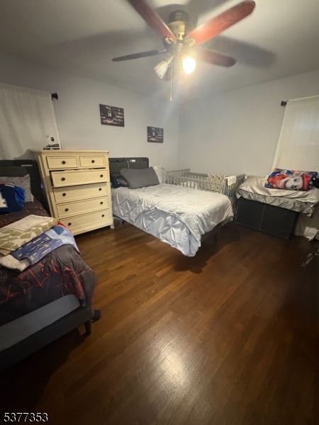 128 Grove Street, Unit 2 Bloomfield, NJ 07003 - Photo 32 of 33 a spacious bedroom with a bed and a chandelier