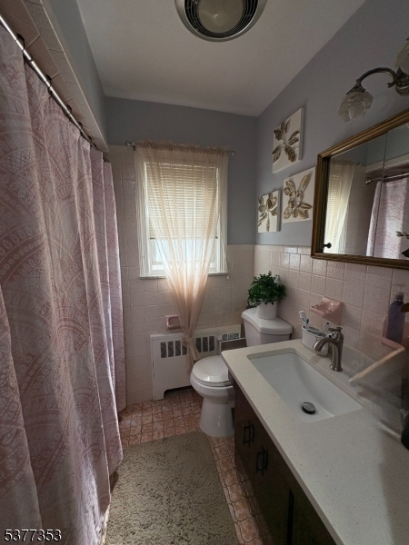 128 Grove Street, Unit 2 Bloomfield, NJ 07003 - Photo 6 of 33 a bathroom with a sink a toilet and mirror