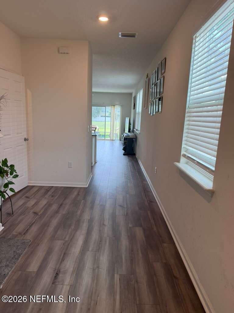 11865 Junegrass Road Jacksonville, FL 32258 - Photo 1 of 17 a view of a hallway with wooden floor and stairs