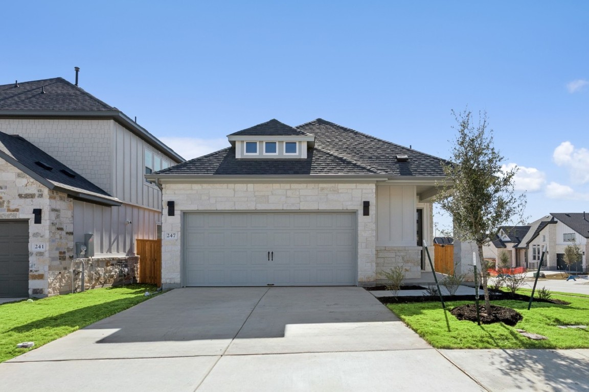 a front view of house with a garden