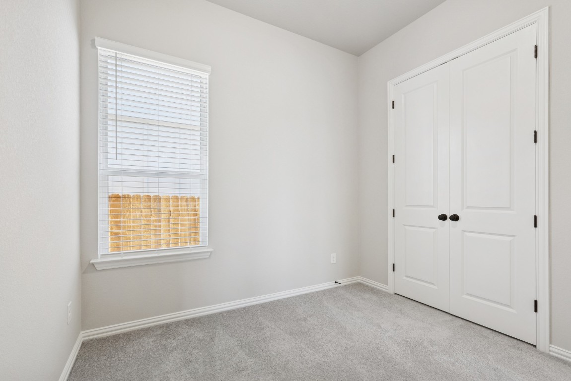 247 Grayson Elm Pass Dripping Springs, TX 78620 - Photo 22 of 39 a view of an empty room with a window