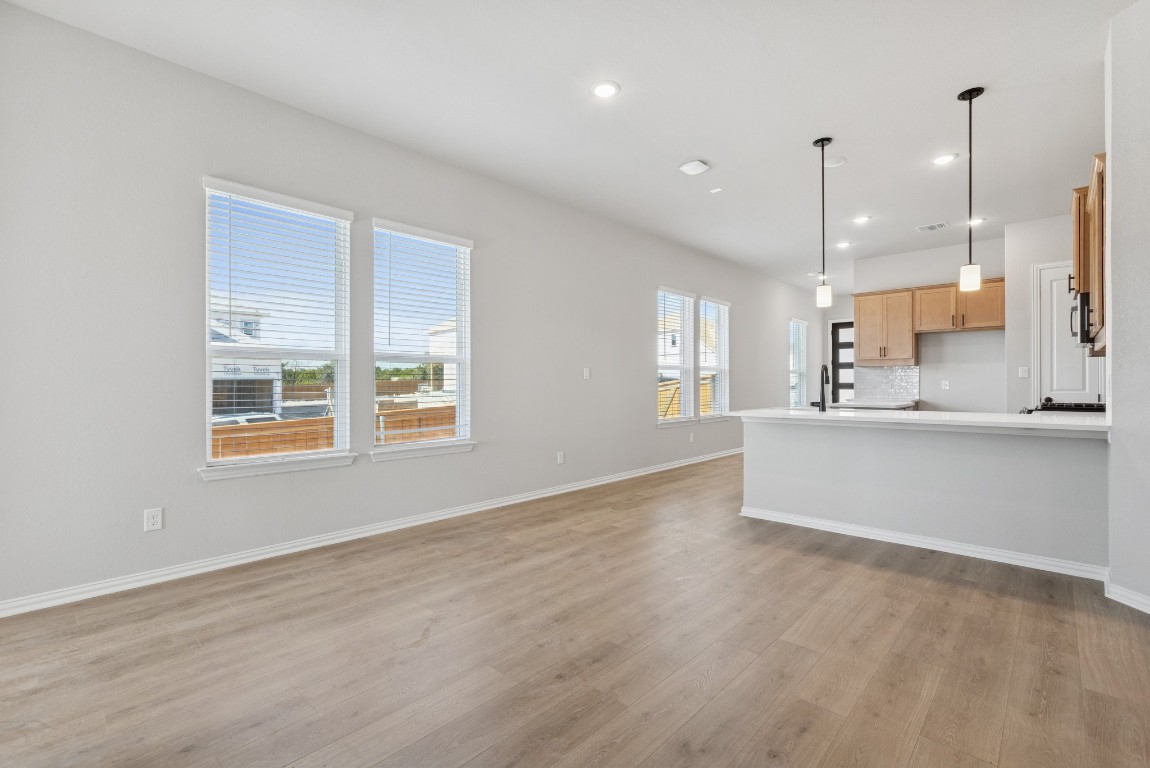 247 Grayson Elm Pass Dripping Springs, TX 78620 - Photo 3 of 39 a view of an empty room with kitchen appliances and a window