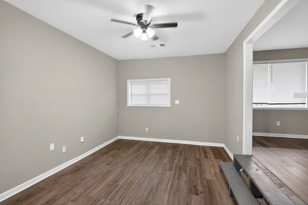 wooden floor in an empty room with a window