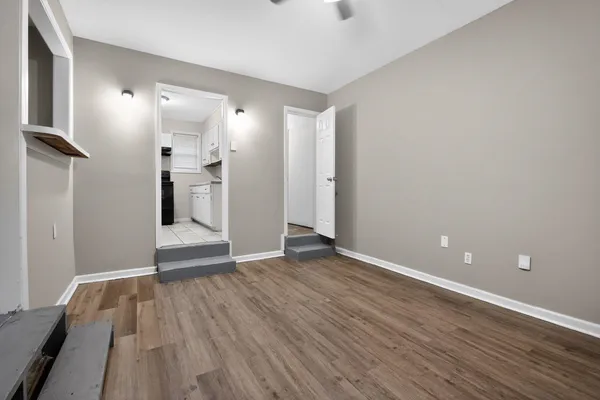 a view of empty room with wooden floor