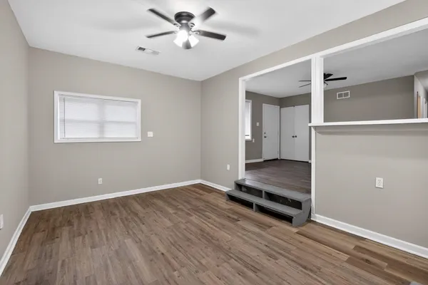 wooden floor in an empty room with a window