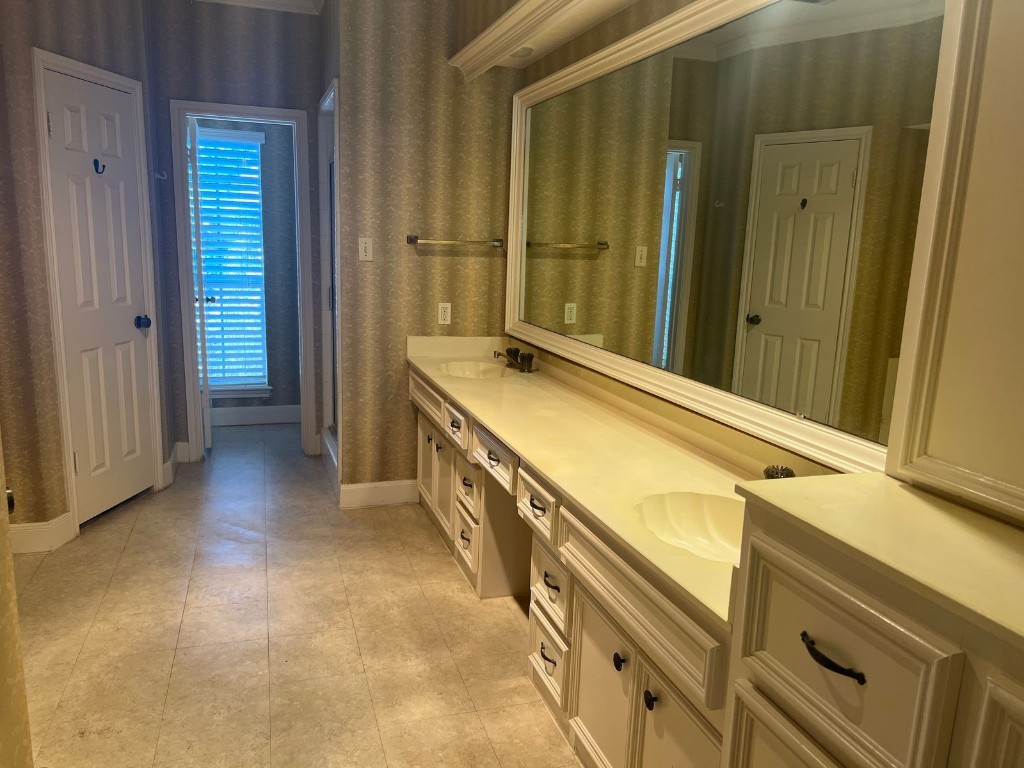 16702 Mandeville Court Spring, TX 77379 - Photo 14 of 15 a view of a bathroom with a sink and a mirror
