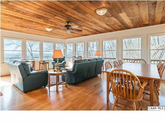 460 Farmview Road Stanardsville, VA 22973 - Photo 5 of 25 The recently refinished sunroom, full of natural light and long banks of windows on three sides...