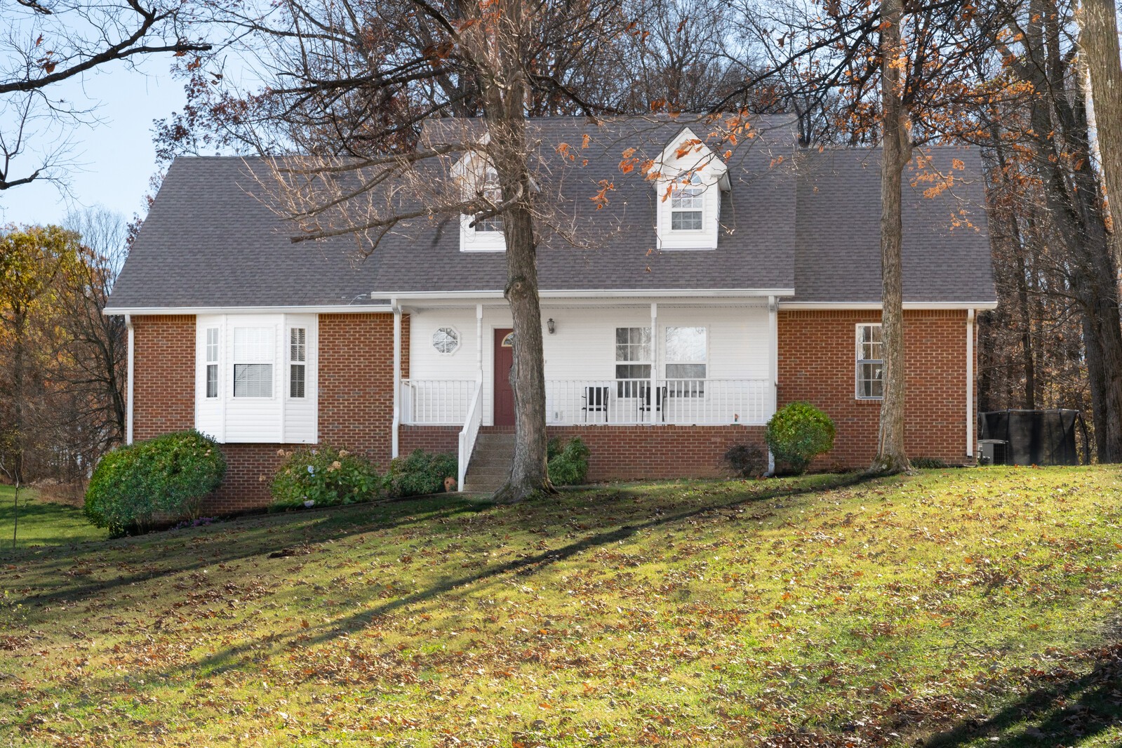 8035 Cedar Grove Road Cross Plains, TN 37049 - Photo 2 of 40 a front view of a house with a yard and garage
