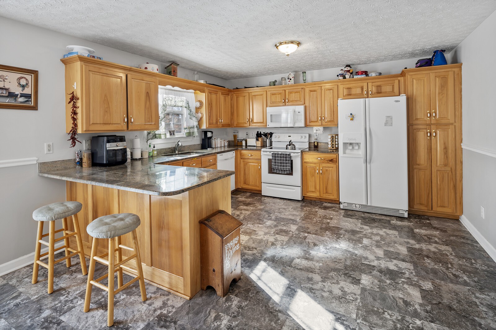 8035 Cedar Grove Road Cross Plains, TN 37049 - Photo 34 of 40 a kitchen with refrigerator and cabinets