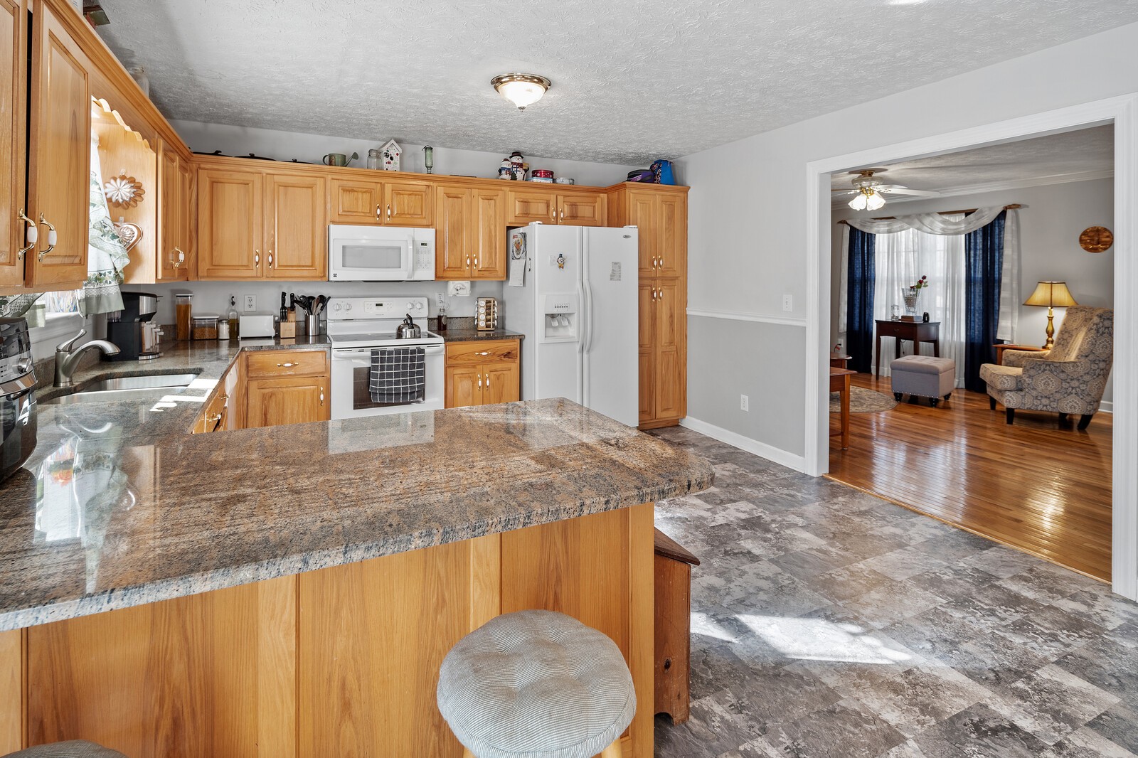 8035 Cedar Grove Road Cross Plains, TN 37049 - Photo 35 of 40 a kitchen with stainless steel appliances granite countertop a sink a stove counter space and cabinets