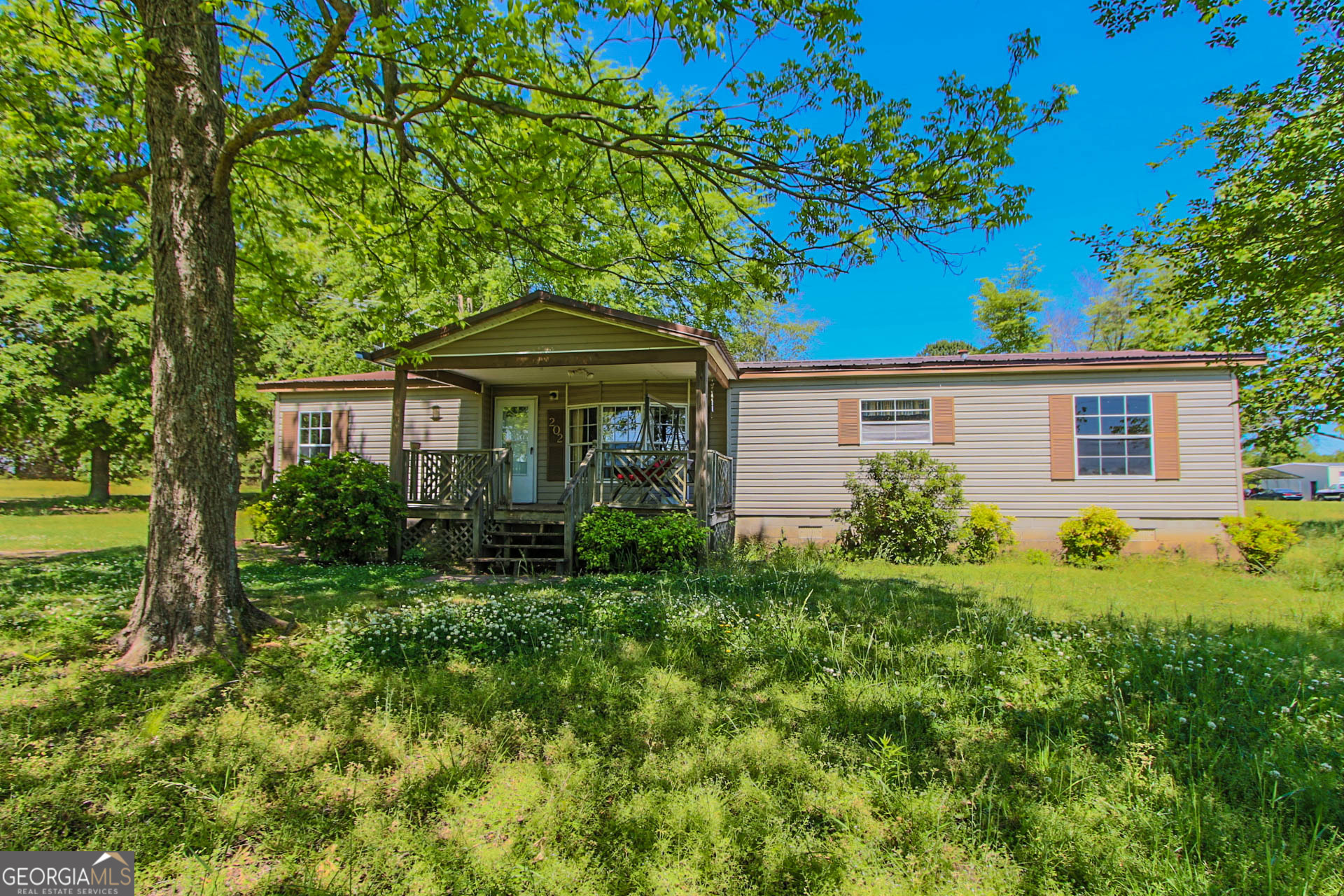 202 Old Alabama Road Milner, GA 30257 - Photo 1 of 1 a front view of a house with garden