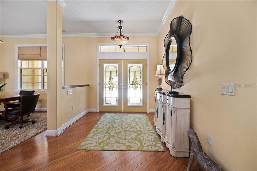 10235 Southeast Sunset Harbor Road Summerfield, FL 34491 - Photo 6 of 50 Enter the large Foyer of this Beautiful Home through the Double leaded glass doors!