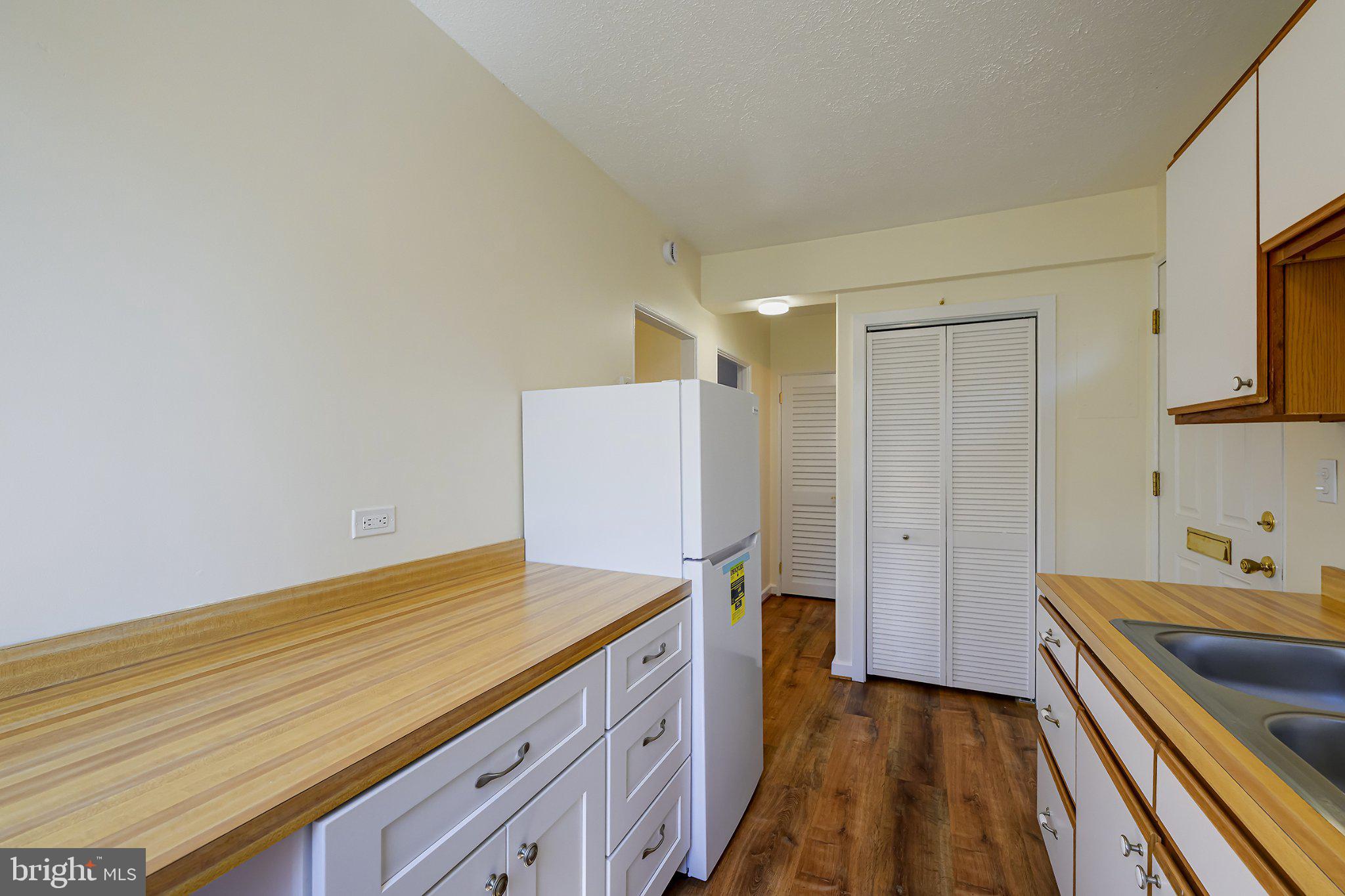 39 Ridge Road Greenbelt, MD 20770 - Photo 11 of 19 a kitchen with a sink and wooden floor