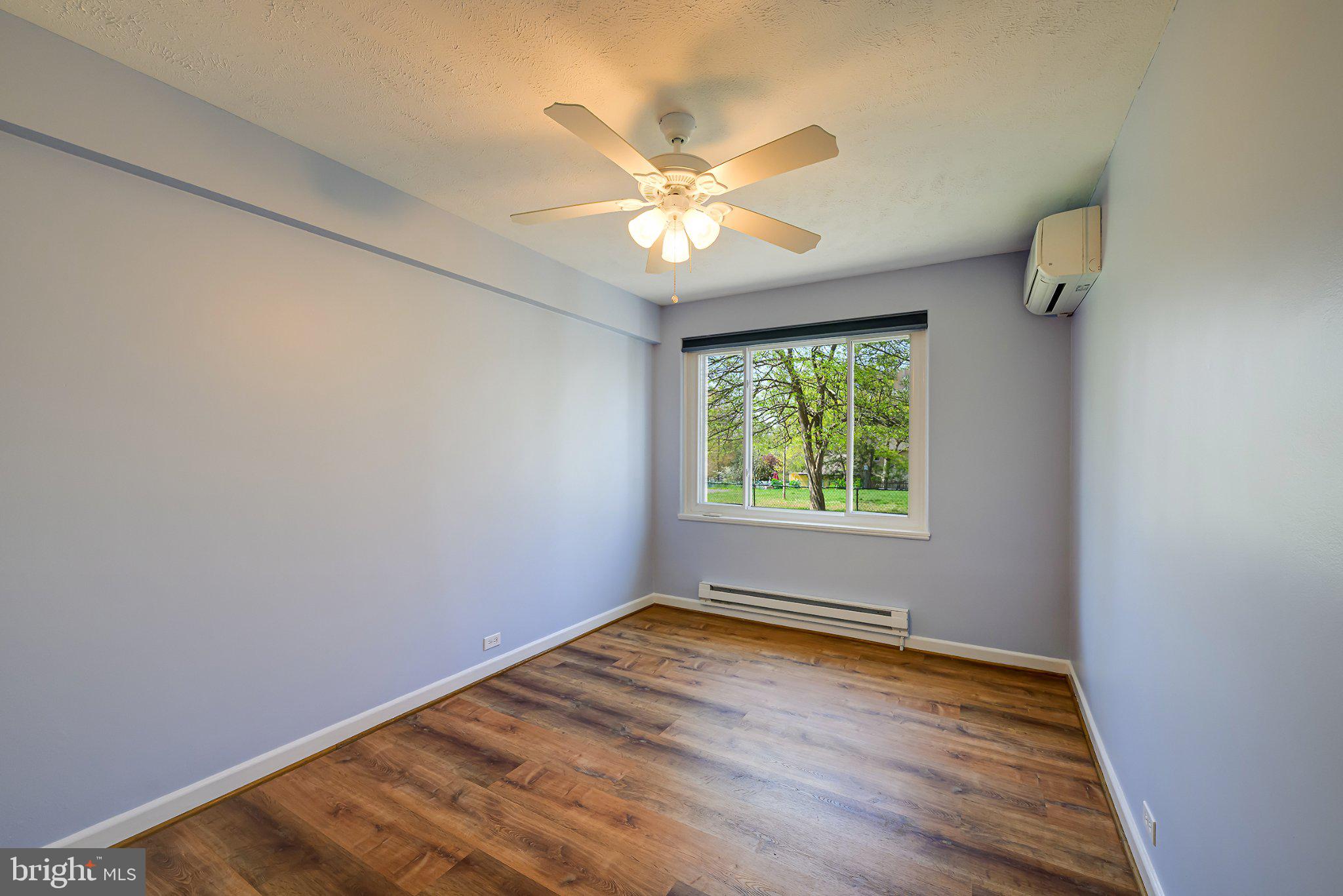 39 Ridge Road Greenbelt, MD 20770 - Photo 13 of 19 wooden floor in an empty room with a window