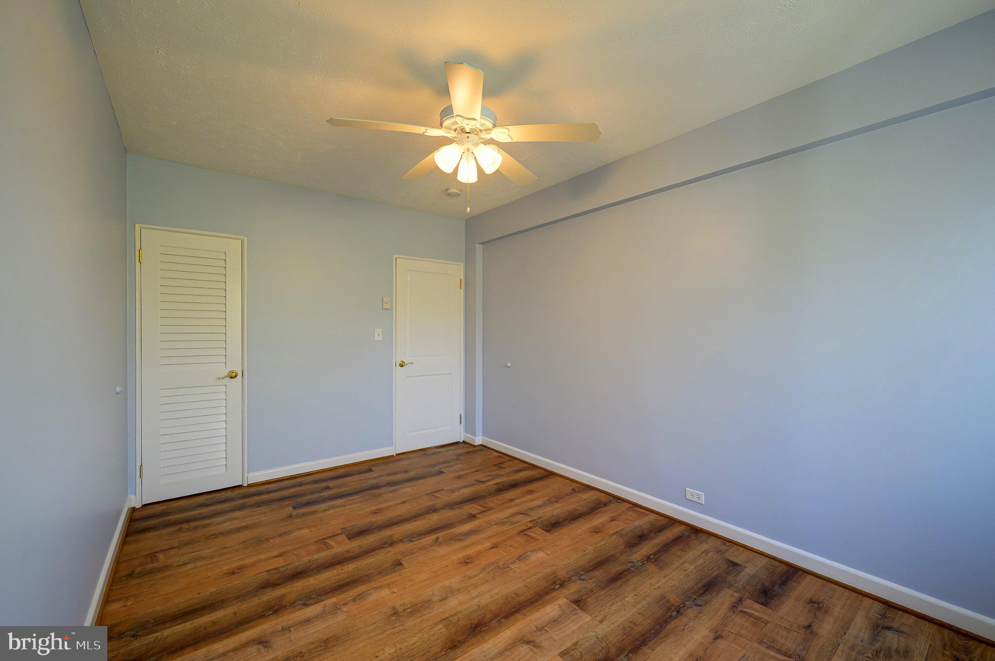 39 Ridge Road Greenbelt, MD 20770 - Photo 14 of 19 a view of a big room with wooden floor and chandelier fan