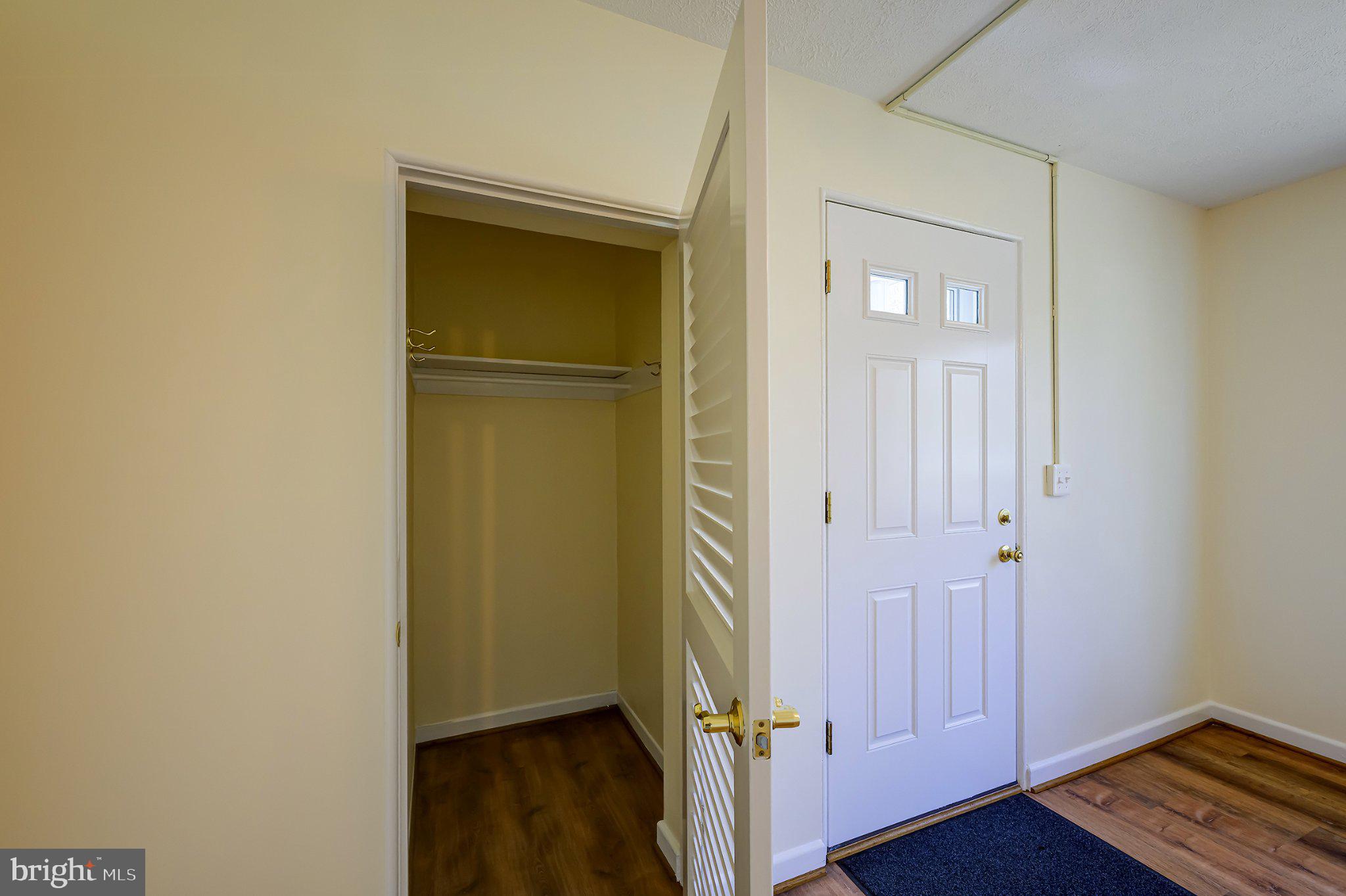 39 Ridge Road Greenbelt, MD 20770 - Photo 7 of 19 an empty room with wooden floor and closet area