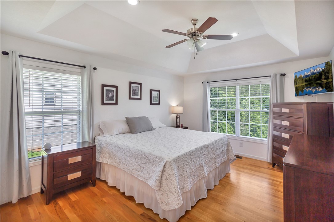 131 Morgan Road West Union, SC 29696 - Photo 11 of 39 Wood flooring and generous windows enhance this peaceful primary bedroom.