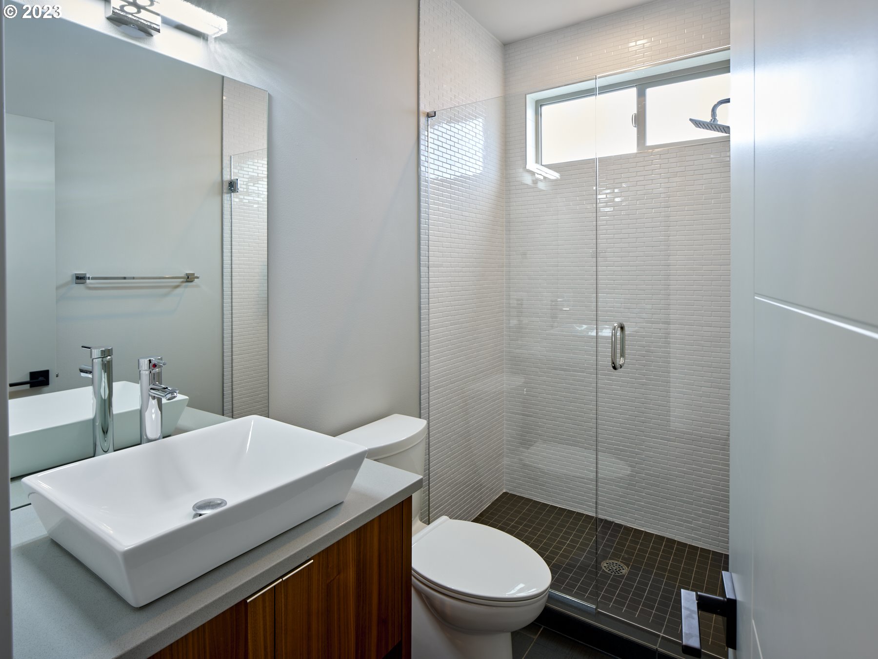4633 North Adams Street Camas, WA 98607 - Photo 22 of 40 a bathroom with a sink a toilet a mirror and shower