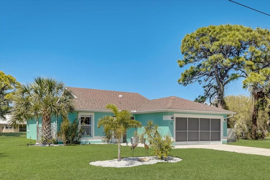 71 Marker Road Rotonda West, FL 33947 - Photo 1 of 1 a front view of a house with a garden