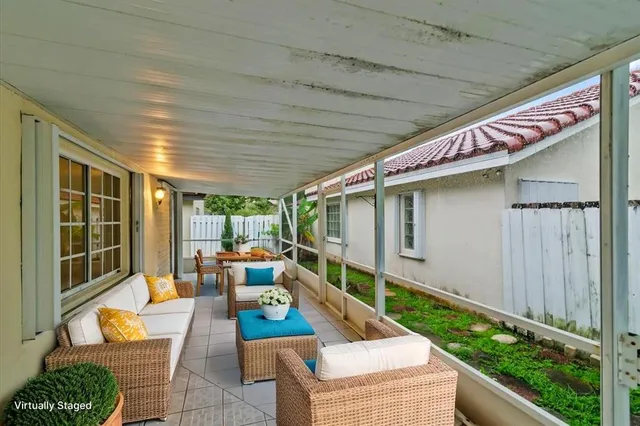 a view of a livingroom with furniture and a ceiling fan
