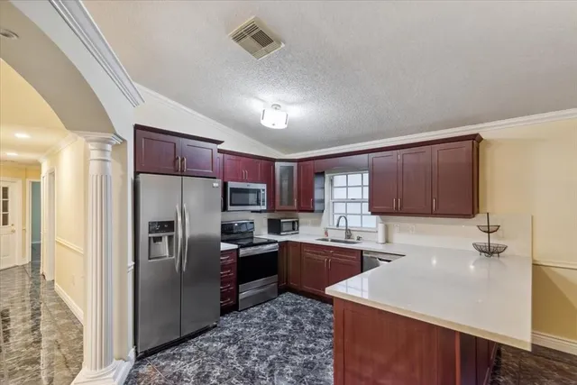 a living room with furniture and view of kitchen
