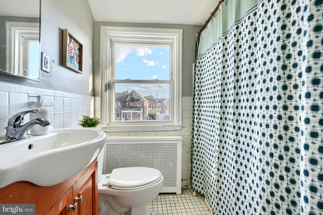 a bathroom with a sink a mirror and a shower