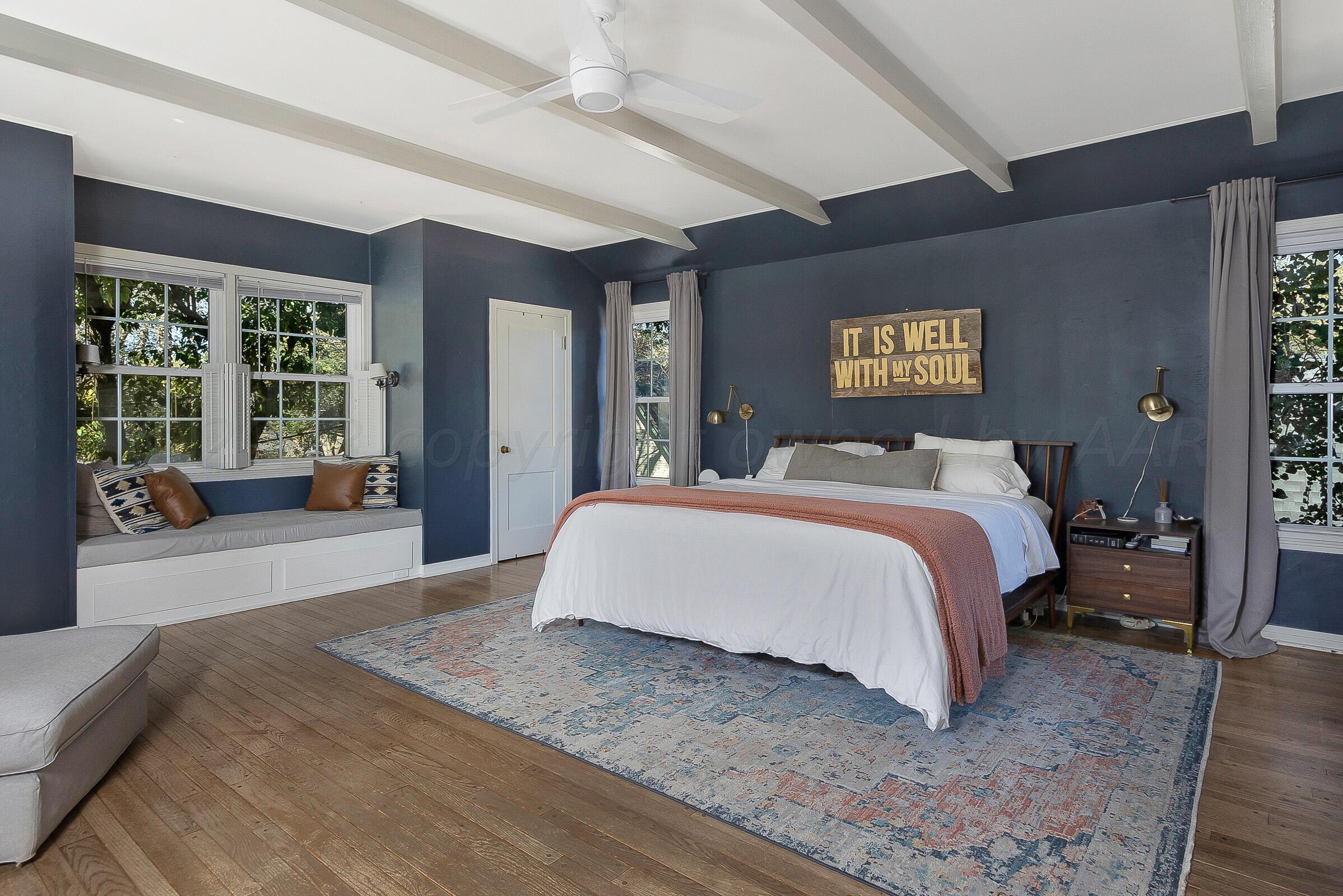 2102 South Hayden Street Amarillo, TX 79109 - Photo 20 of 33 a spacious bedroom with a large bed and a large window