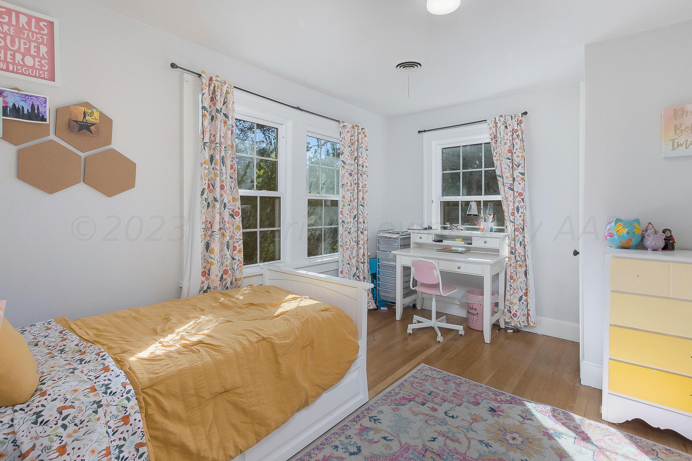 2102 South Hayden Street Amarillo, TX 79109 - Photo 25 of 33 a bedroom with a bed and wooden floor