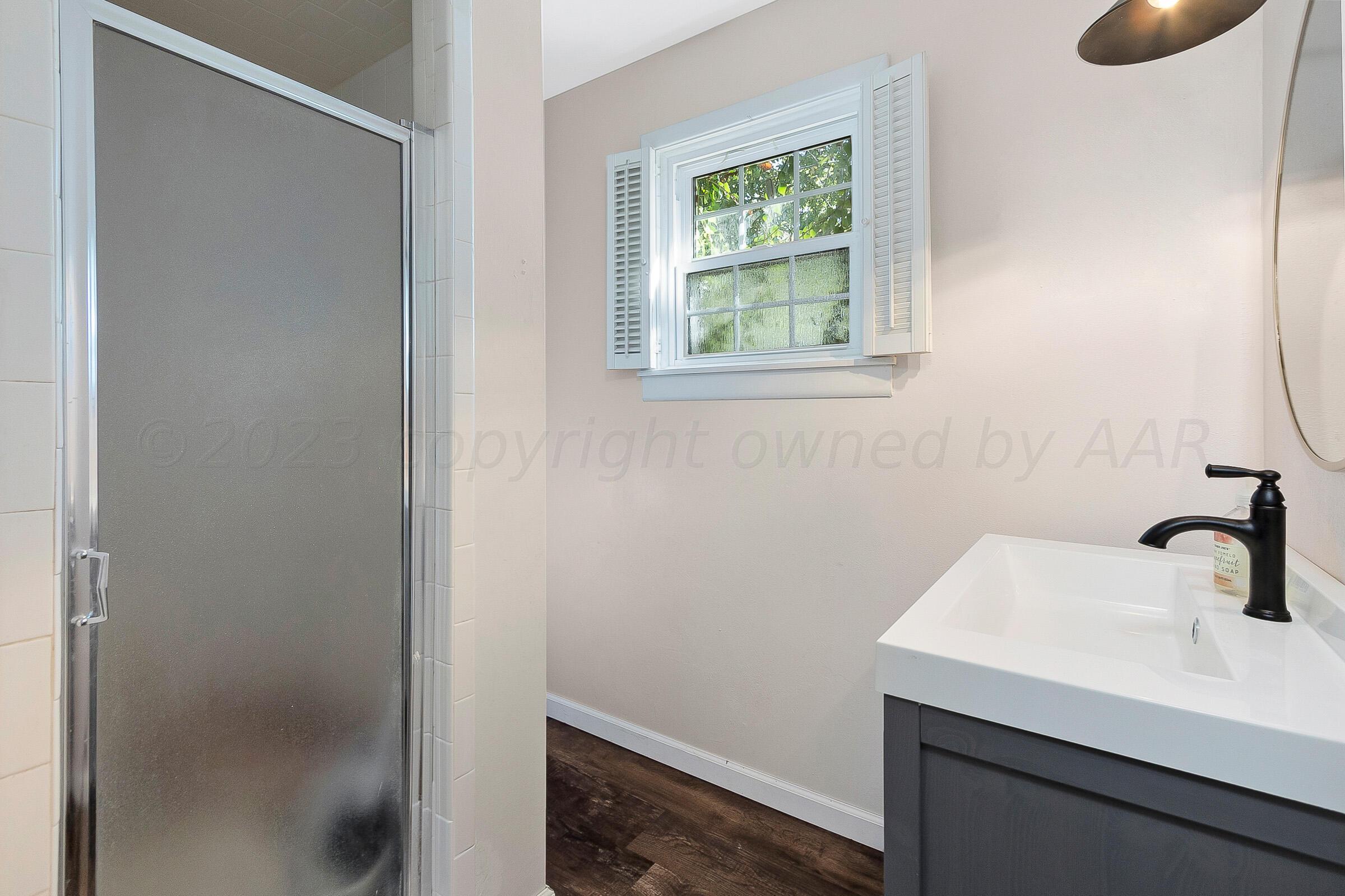 2102 South Hayden Street Amarillo, TX 79109 - Photo 26 of 33 a bathroom with a sink and a mirror
