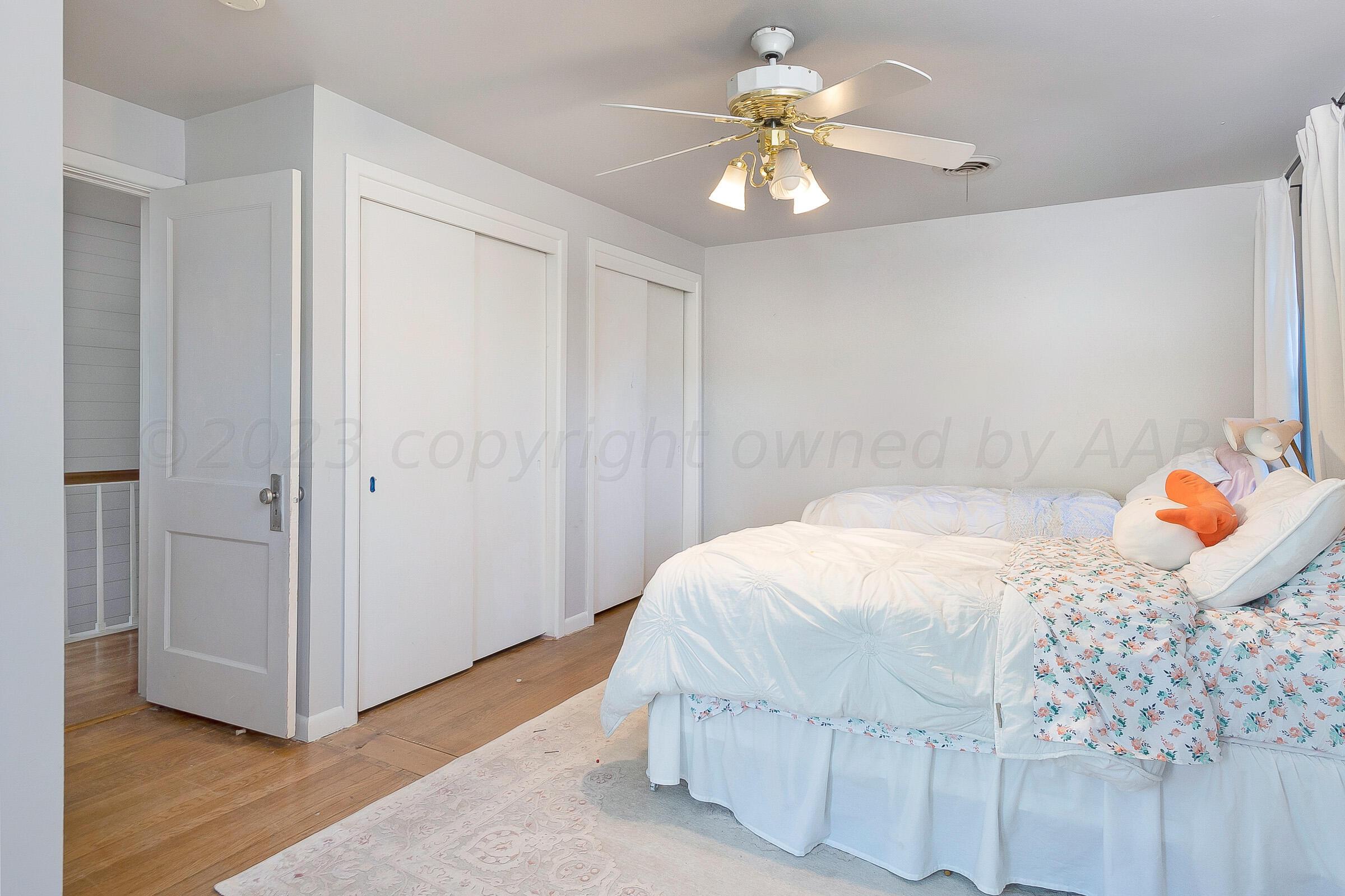 2102 South Hayden Street Amarillo, TX 79109 - Photo 30 of 33 a bedroom with a bed and a chandelier