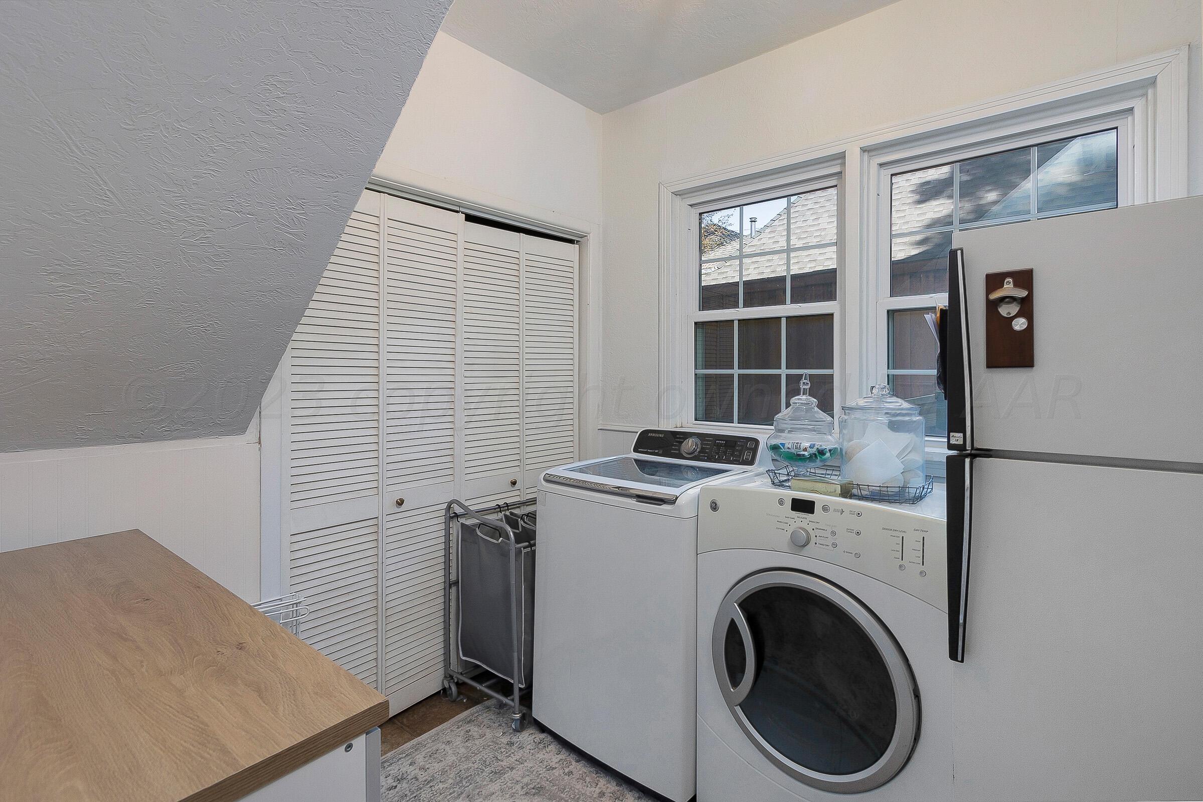 2102 South Hayden Street Amarillo, TX 79109 - Photo 32 of 33 a view of washer and dryer with kitchen in the background