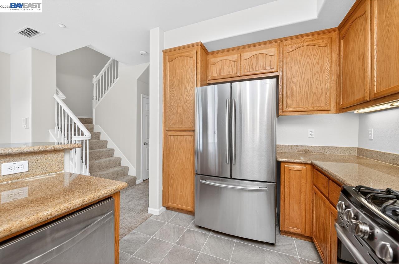 3391 Monaghan Street Dublin, CA 94568 - Photo 11 of 57 a kitchen with stainless steel appliances granite countertop a refrigerator and a sink