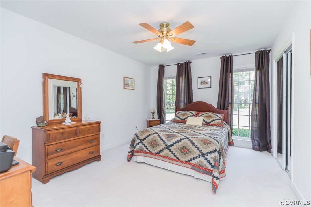 4829 Wakema Road West Point, VA 23181 - Photo 12 of 36 a bedroom with two beds and a chandelier