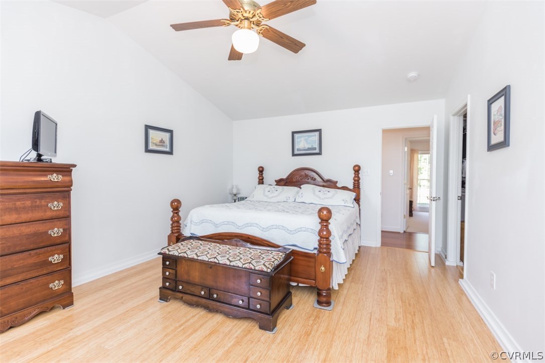4829 Wakema Road West Point, VA 23181 - Photo 15 of 36 a bedroom with a bed and a chandelier