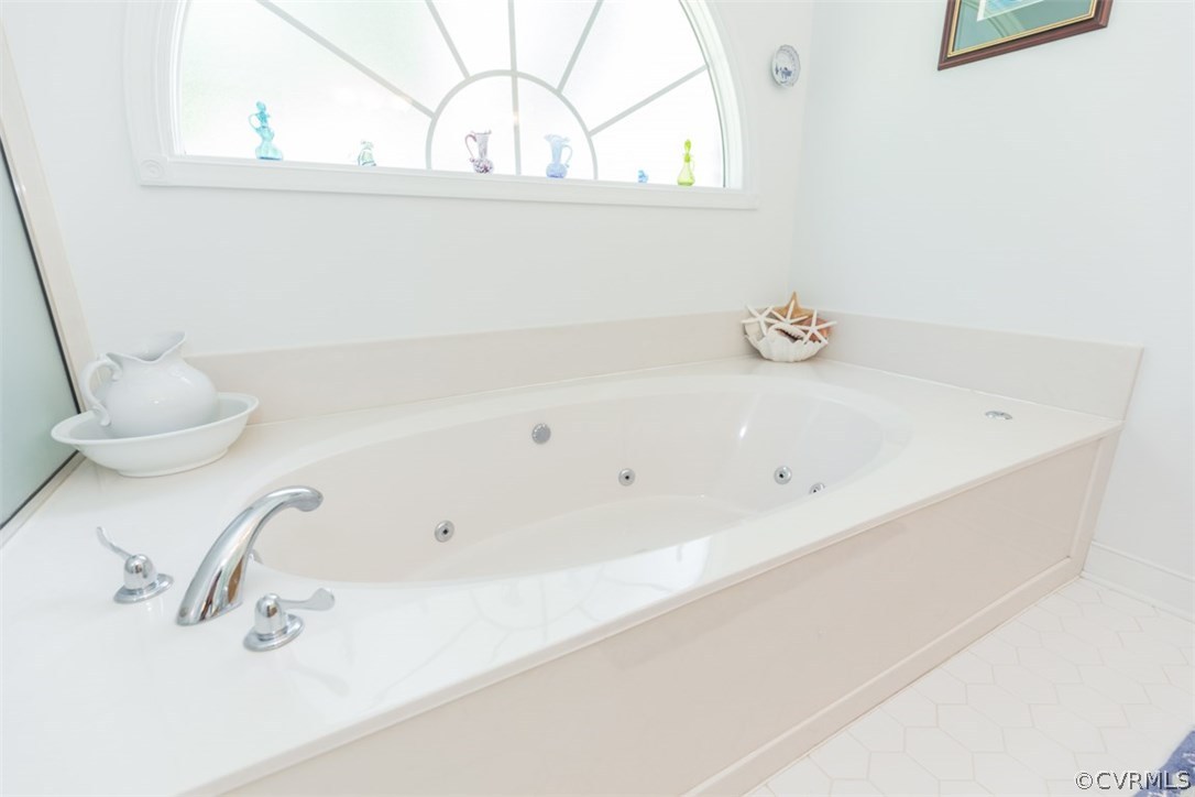 4829 Wakema Road West Point, VA 23181 - Photo 16 of 36 a bathroom with a bathtub and a window