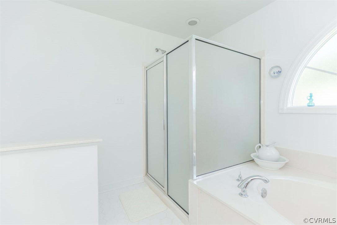 4829 Wakema Road West Point, VA 23181 - Photo 18 of 36 a bathroom with a bathtub and a shower