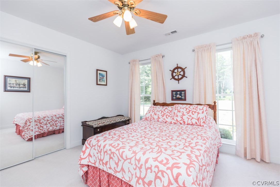 4829 Wakema Road West Point, VA 23181 - Photo 19 of 36 a bedroom with a large bed and a chandelier