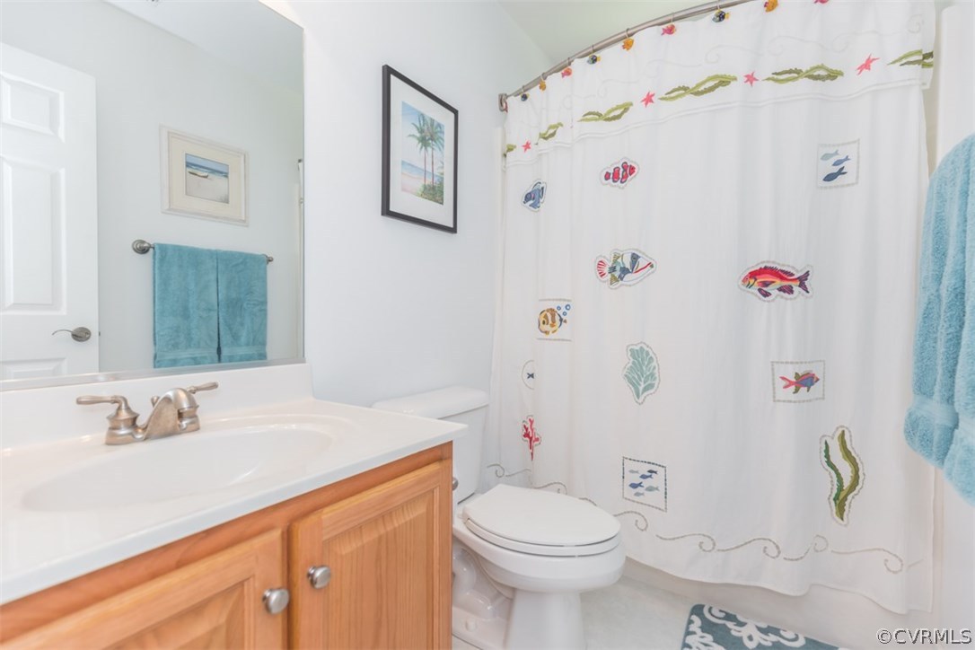 4829 Wakema Road West Point, VA 23181 - Photo 20 of 36 a bathroom with a sink a toilet and shower curtain