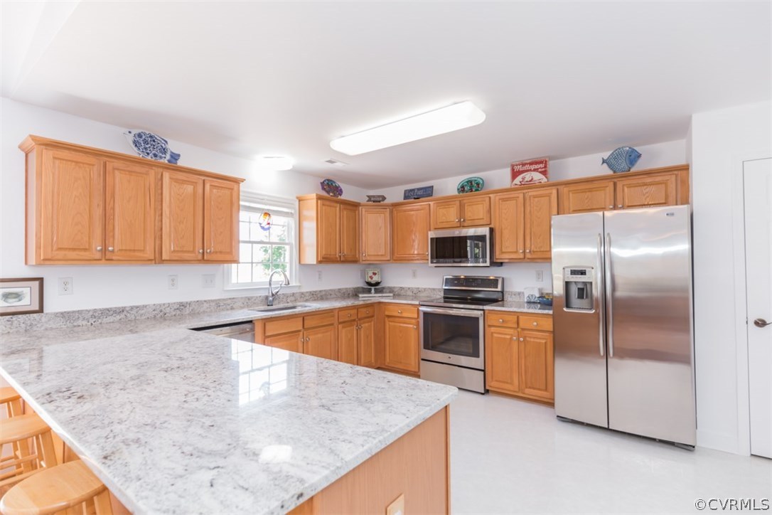 4829 Wakema Road West Point, VA 23181 - Photo 6 of 36 a kitchen with stainless steel appliances granite countertop a sink a stove and a refrigerator